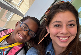  A female teacher and a male student smiling